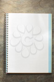 checked notebook at grunge background