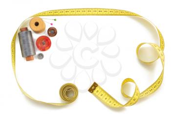 sewing tools and measuring tape isolated on white background