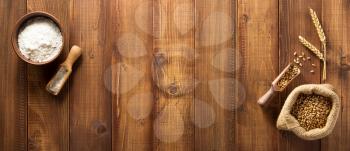 wheat grains on wooden plank background