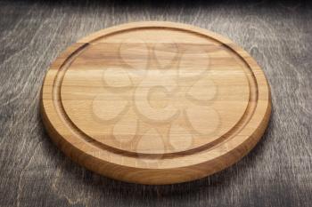 pizza cutting board at rustic wooden table in front