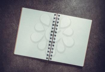checked notebook on background texture