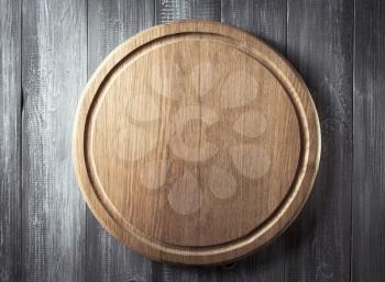 pizza cutting board at rustic wooden background