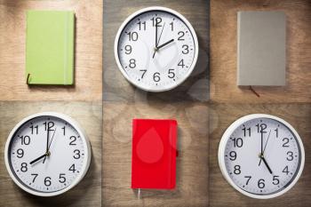 notebook and wall clock at wooden background surface