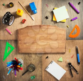 school supplies at abstract wooden background