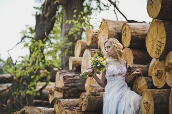 The girl among logs.