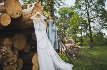 Clothes placed on logs in the wood.