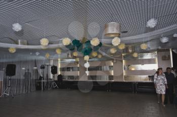 The festive hall is decorated with paper balls.