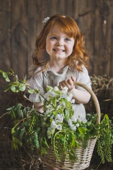 Studio portrait of red-haired little girls in the hay.