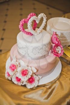 Sweet cake decorated with pink hearts and flowers.