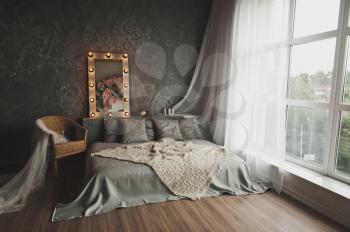 Studio decorated in the form of a bed near the window.