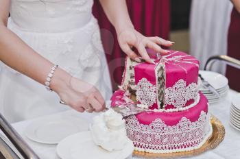 Pink with white decorations cake.