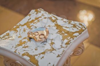 Gold jewelry on a marble counter.