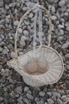 Openwork basket in the shape of a hat with a high handle.