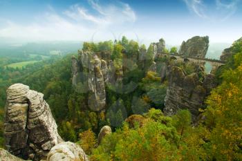 Bridge named Bastei in Saxon Switzerland Germany on a sunny day in autumn with colored trees and leafs