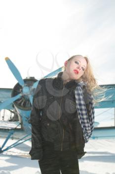 sexy young girl next to the pilot vintage aircraft