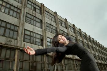 girl falls against the prospects of an old abandoned factory