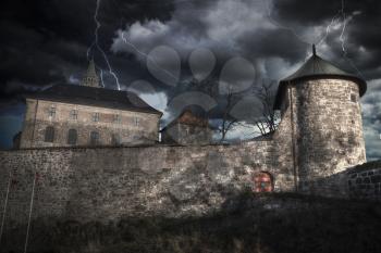 Heavy thunderstorm with lightning. fortress of Akershus - a castle in Oslo, the capital of Norway.