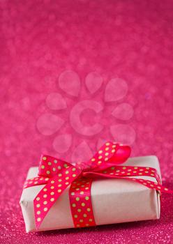 box for present with red ribbon on the wooden table