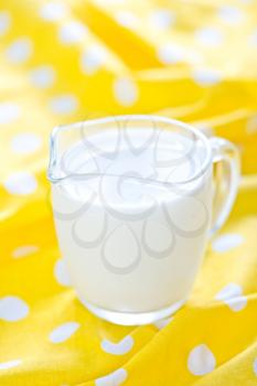 fresh milk in glass jug and on a table