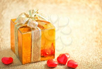 box for present and hearts on a table