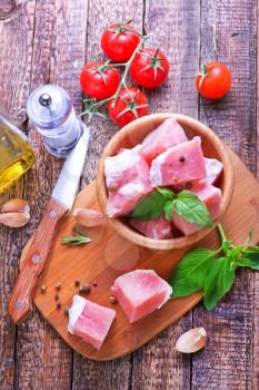 raw meat with salt and pepper in the bowl