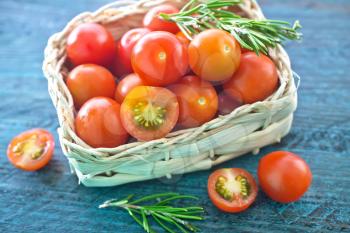 fresh tomato cherry in basket and on a table