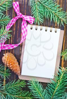 note and brunch of christmas tree on wooden table