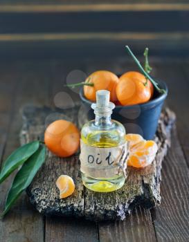 aroma oil and tangerines on the wooden board