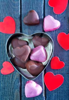 chocolate candy on the wooden table, chocolate hearts