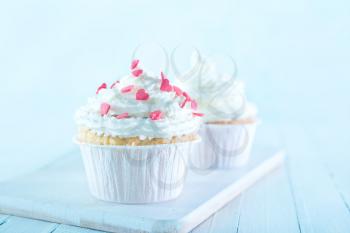 muffins with white cream on a table