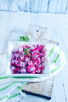 beet salad in bowl and on a table