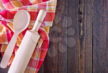 wooden rolling pin and napkin on a table