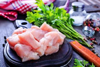 raw meat on board and on a table