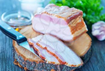 smoked lard on wooden board and on a table