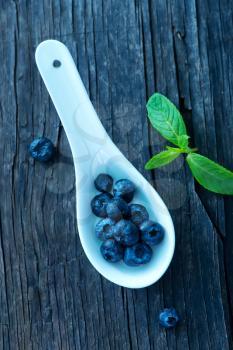 fresh blueberry on the wooden board, berries on a table