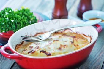 potato gratin in bowl and on a table