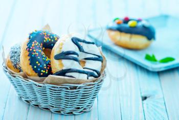 sweet donuts in basket and on a table