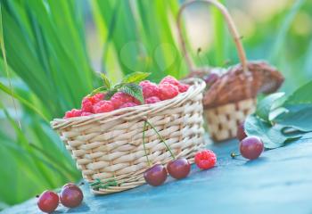 fresh raspberry in basket and on a table