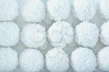 coconut balls with cream on the white table