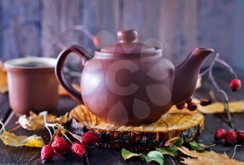 fresh tea in teapot on the wooden table