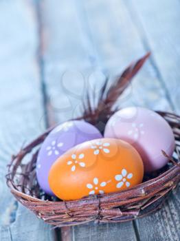 easter eggs in the nest and on a table