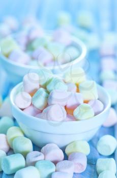 color marshmallow in bowl and on a table