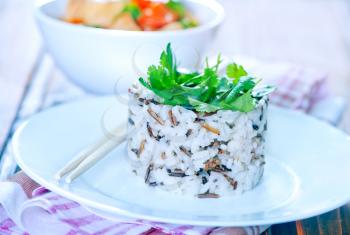 boiled rice on plate and on a table