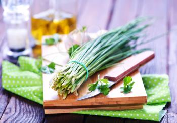 green onion on board and on a table