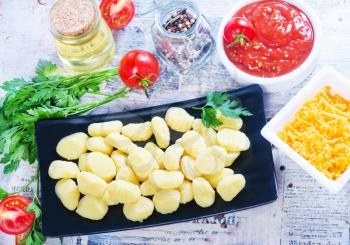 potato gnocchi with sauce on the kitchen table