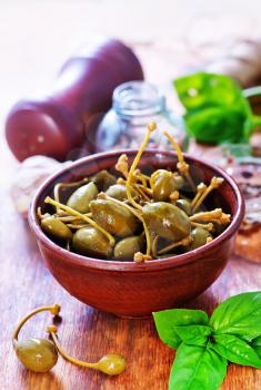 capers in bowl and on a table