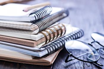 Stack of spiral notebooks on a table