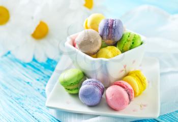 color macaroons in bowl and on a table
