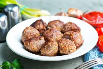 fried meatballs on plate and on a table