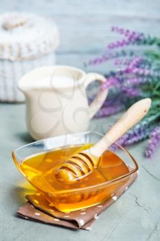 honey in glass bank and on a table